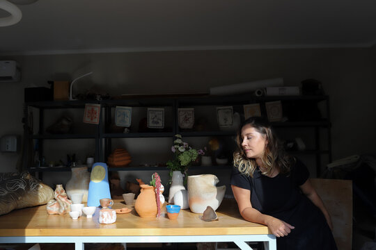 woman with ceramic vase in studio