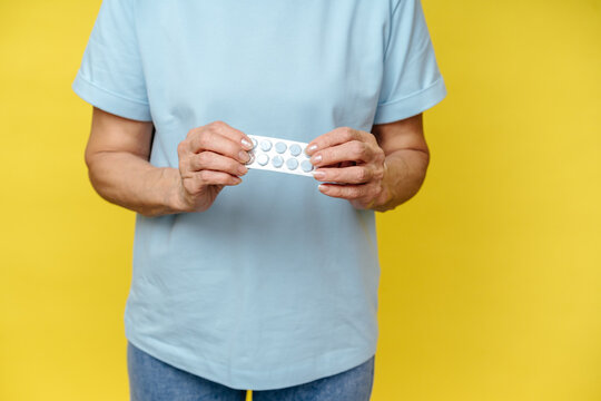 Close-Up of Elderly Woman Holding Blister Pack of Pills