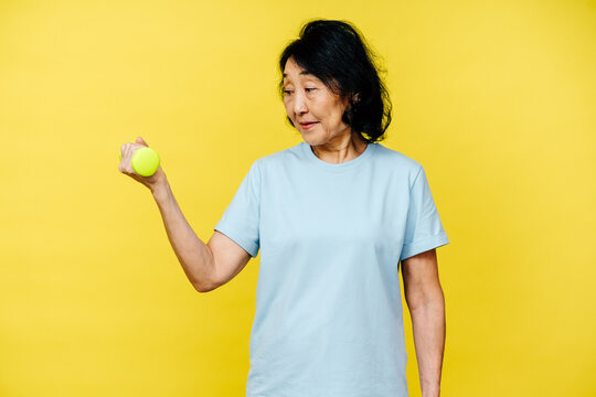 Senior Woman Exercising with Light Green Dumbbell