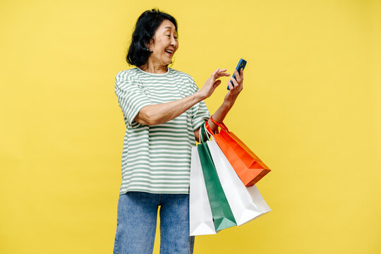 Cheerful Senior Woman Shopping and Using Smartphone