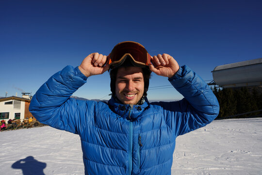 Portrain of man with red googles and black helmet.
