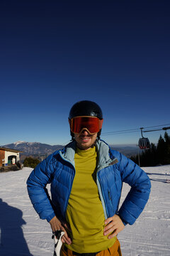Portrain of man with red googles and black helmet.