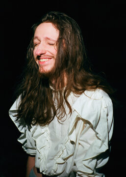 Portrait of an Androgynous Person Smiling at Night