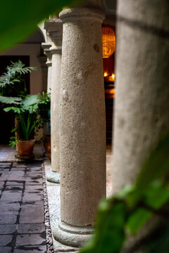 Stone column framed by blurred leaves