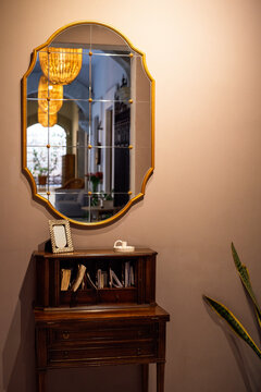 Wall with vintage des and golden frame mirror
