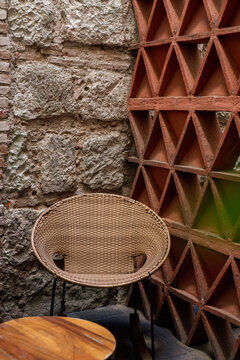 Patio straw chair with triangular brick wall