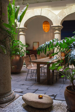 Rustic dining table in patio with stone columns