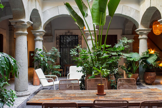 Outdoor internal patio with lounge chairs and dining table