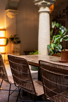 Patio dining table with straw modern chairs 