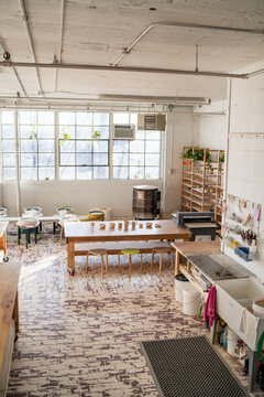 Spacious pottery studio with kiln and wheels  
