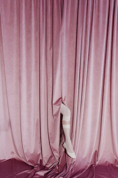 Anonymous Woman Leg Emerging from Pink Curtain