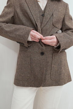 Woman Buttoning Blazer