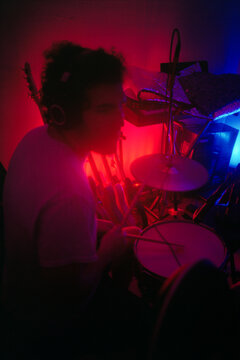 Young Man Plays the Drums at Home Studio