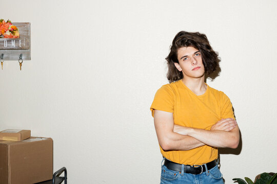 Portrait of Non-Binary Person in Front of a White Wall at Home