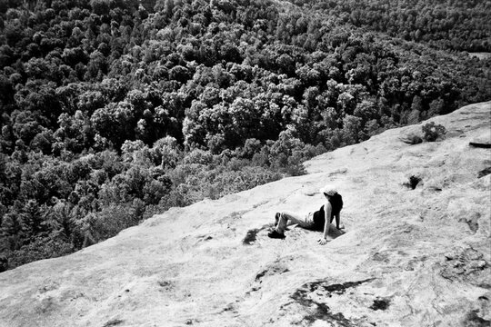 Woman Rests on Lookout above Trees