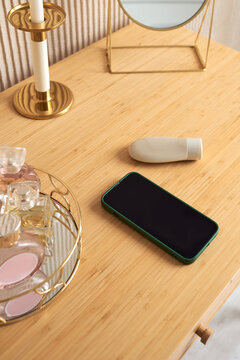 Phone on the table among beauty supplies 