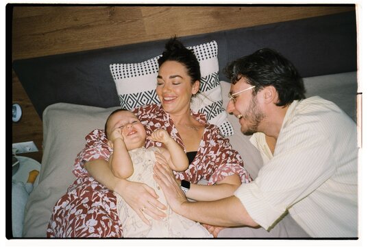 Joyful family moment captured in cozy bedroom