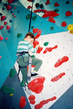 Direct flash film photo of child at indoor climbing gym