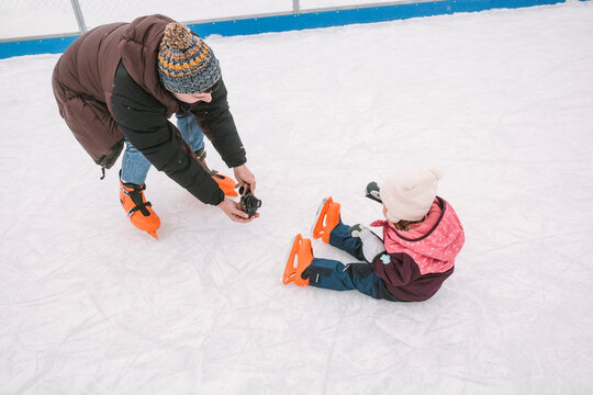 photographing child on ice rink