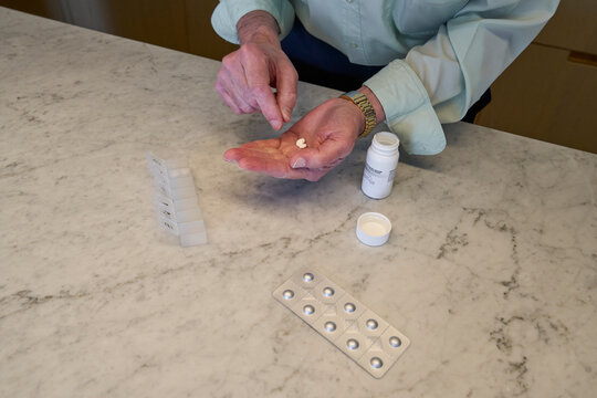 Preparing medication for daily intake at home in the afternoon