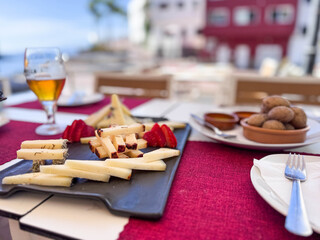 Cheese Platter With Strawberries, Potatoes and Beer At Outdoor Seaside Restaurant Table in Alcala square, Tenerife © Snapvision
