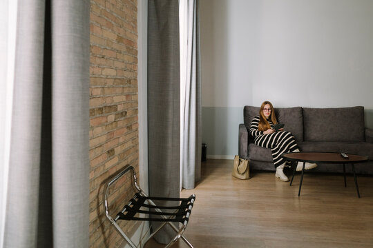Woman relaxing in hotel lounge