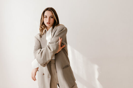 Confident woman in contemporary beige suit
