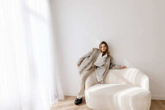 Trendy woman on white sofa