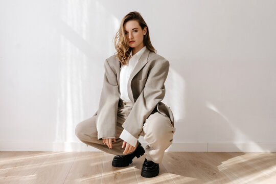 Stylish woman in neutral-toned outfit