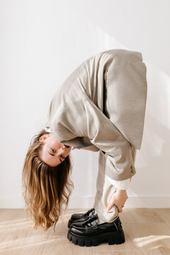 Trendy woman bending forward
