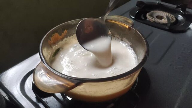 The process of boiling evaporated milk with pandan leaves to give it a distinctive aroma.