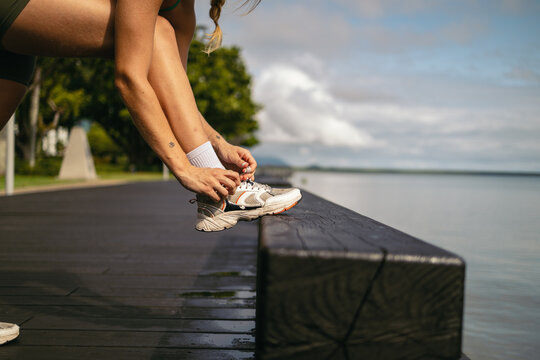 Close up of a sports woman tying her shoelaces