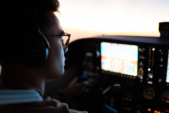 Pilot Flying at Sunset with Glass Cockpit Display