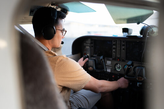 Pilot Starting Engine Inside Cockpit of Light Aircraft