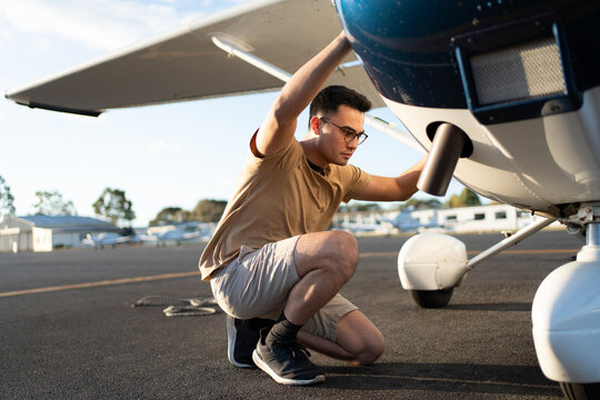 Young Pilot Performing Pre Flight Inspection on a Small Aircraft