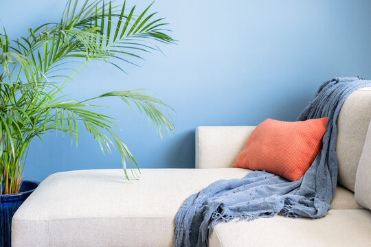 Beige sofa on blue wall living room