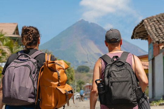 Travelers with Backpacks Facing Concepci&oacute;n Volcano