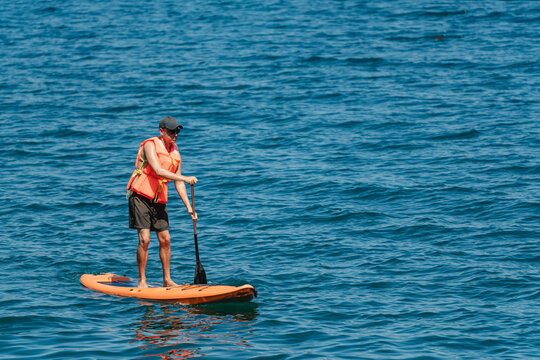 Man paddleboarding on the water