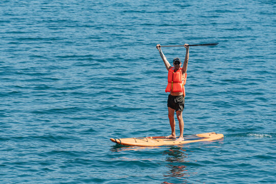 Man celebrating on a paddleboard