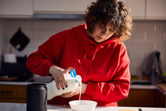 Woman making cereal for breakfast