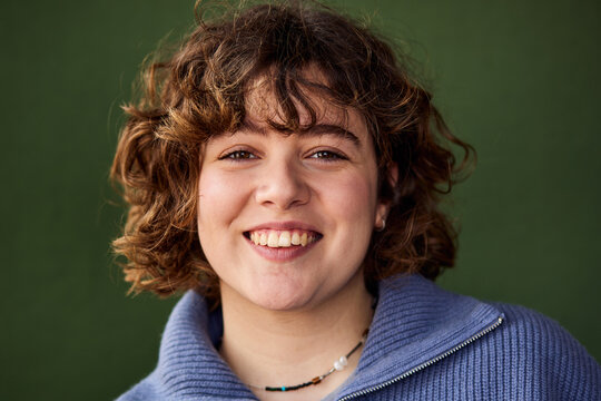 Woman wearing a blue sweater and smiling