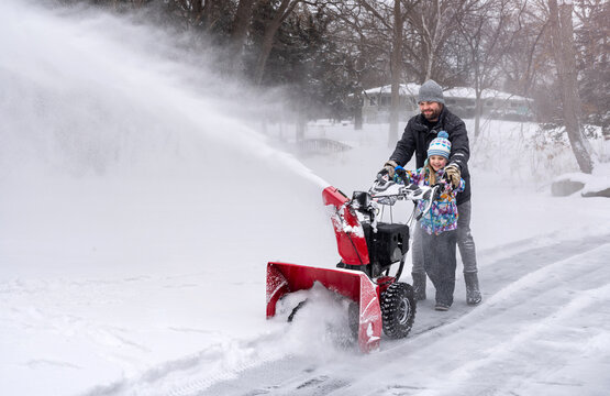 Snowblowing ice rink together wide