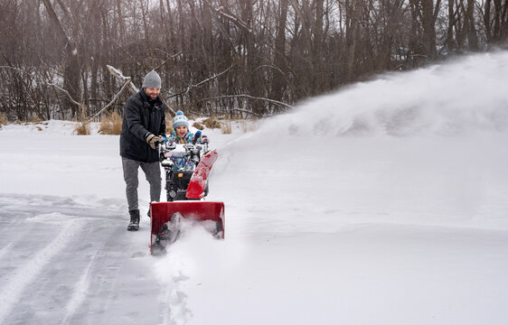 Snowblowing ice rink together
