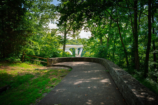 A shady trail walkway leading to the observation point trail overlooking the Natchez Trace Parkway Bridge, a concrete double arch bridge in Franklin, Tennessee.	