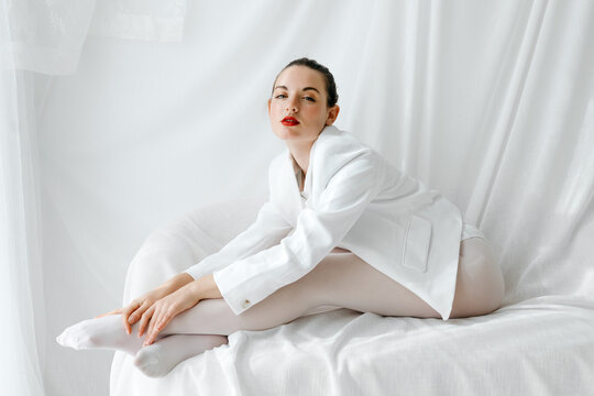 Elegant woman stretching in a white outfit