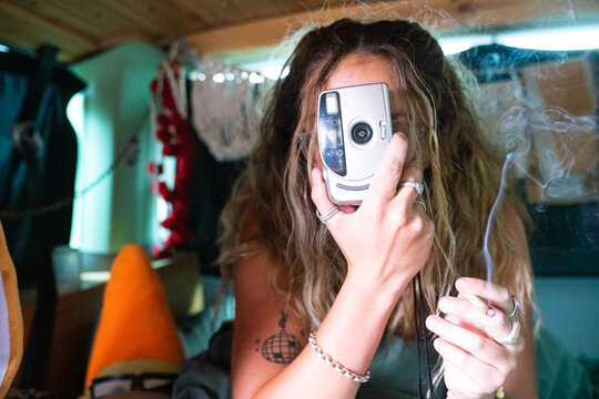 Girl in a cosy van photographing me 