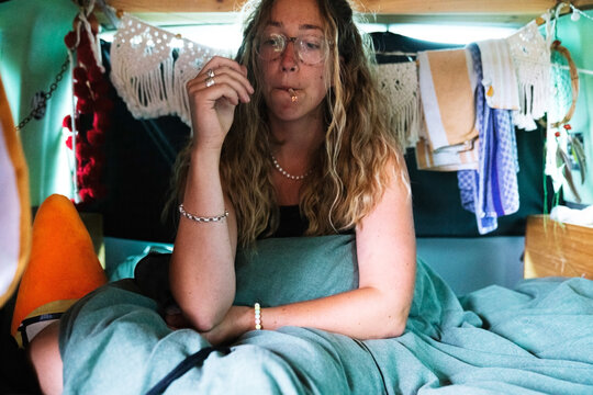 Girl in a cosy van smoking joint