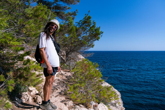 Young man happy at a cliffy beach