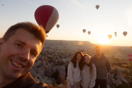 selfie young man with friends on the background of balloons