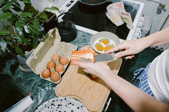 Top-Down View of Hands Chopping Bell Pepper for Breakfast